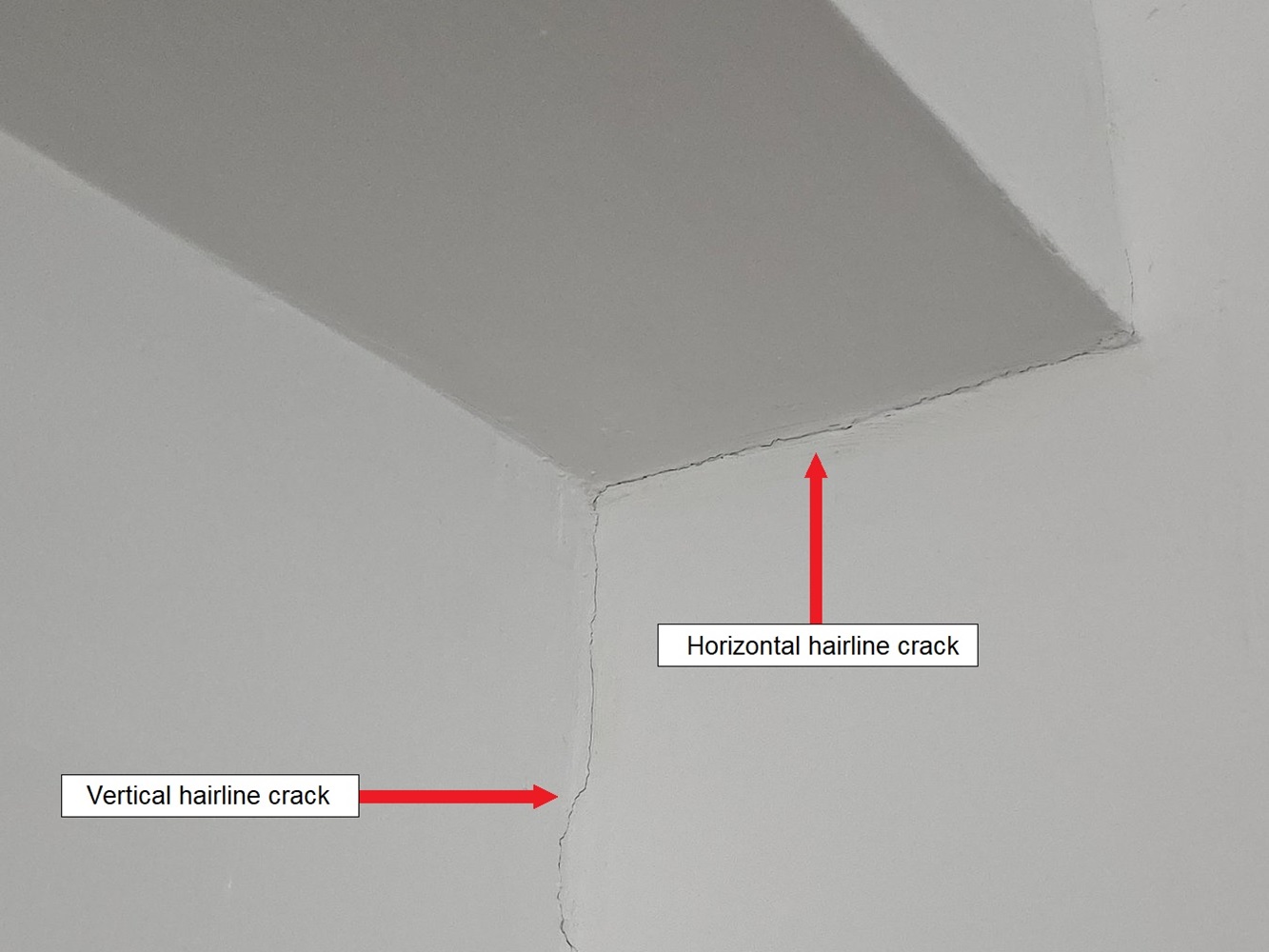 Hairline, non-structural cracks in the plaster of a wall