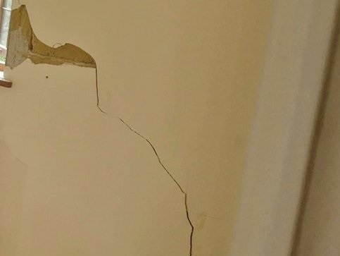 Structural cracks in the plaster of a wall